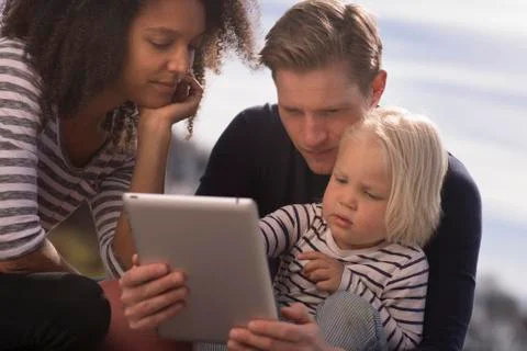 Son with parents using tablet Stock Photos
