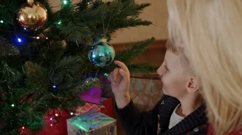 Son playing with christmas tree ball Stock Footage