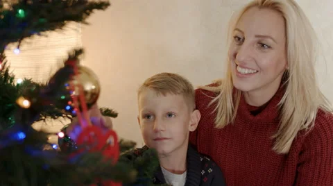 Son playing with christmas tree toy Stock-Footage 67690658