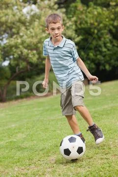 Son posing while playing football Stock Photos