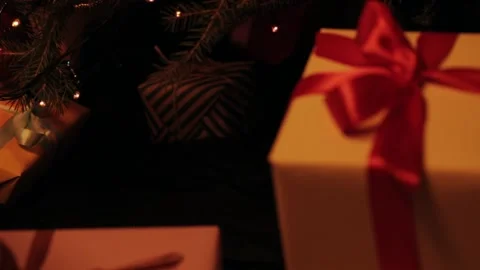 Son puts a gift under the christmas tree. Beautiful presents under the Christmas Video stock 142138837