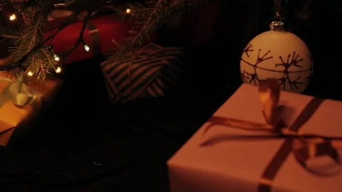 Son puts a gift under the christmas tree. Beautiful presents under the Christmas Video stock 142138840
