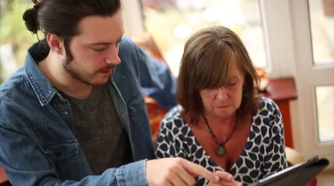 Son Shows Mother How to Use Smart Device Stock Footage 53472360