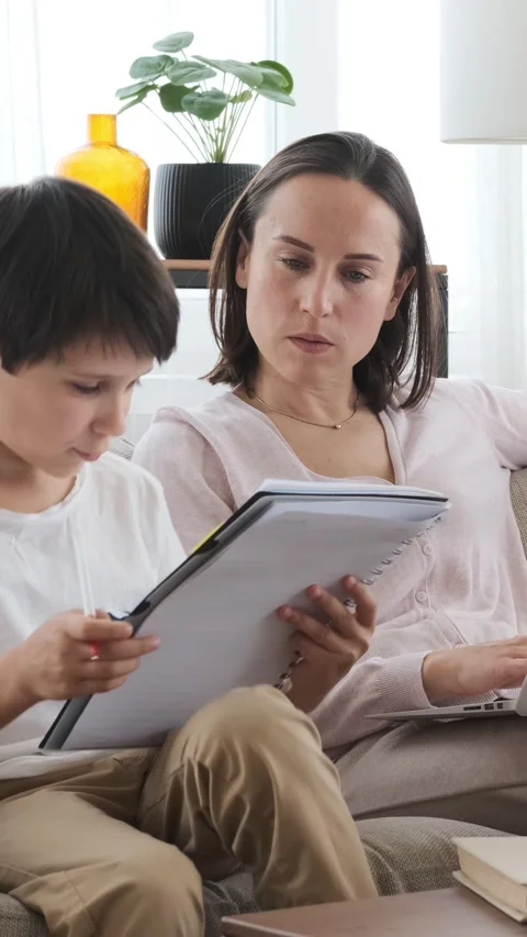 Son Studying Homework While Mother Works At Home Stock Footage 310460723