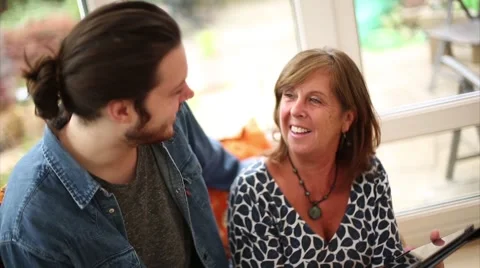 Son Teaches Mom How to Use Tablet Stock Footage 53469802