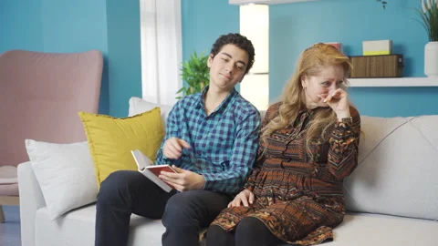 Son teaching his elderly mother how to use a laptop. Stock Footage 233079255