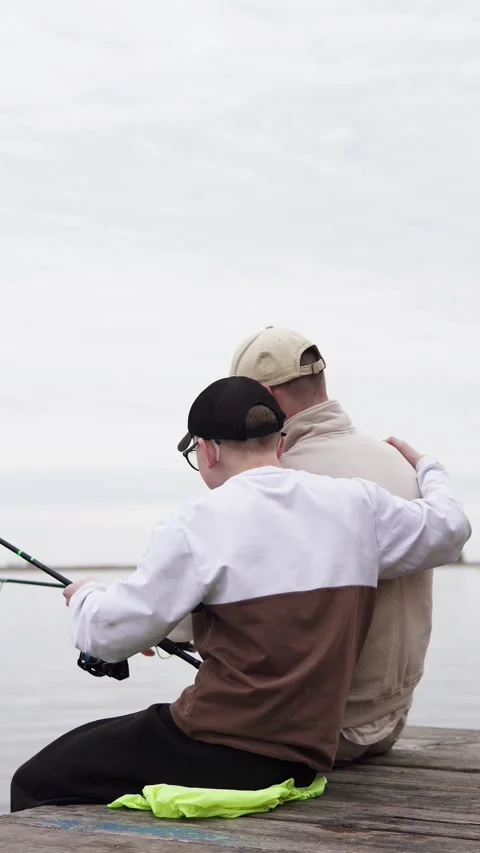 Son thanks dad for taking him fishing and hugs him. Stock Footage 309521588
