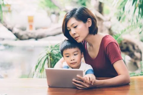 Son using digital tablet computer for study and learn to internet online with 스톡 사진