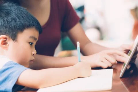 Son using digital tablet computer for study and learn to internet online with 스톡 사진