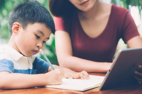 Son using digital tablet computer for study and learn to internet online with 스톡 사진