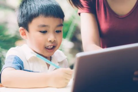 Son using digital tablet computer for study and learn to internet online with 스톡 사진