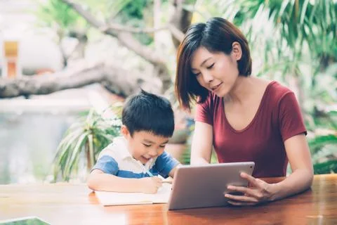 Son using digital tablet computer for study and learn to internet online with 스톡 사진