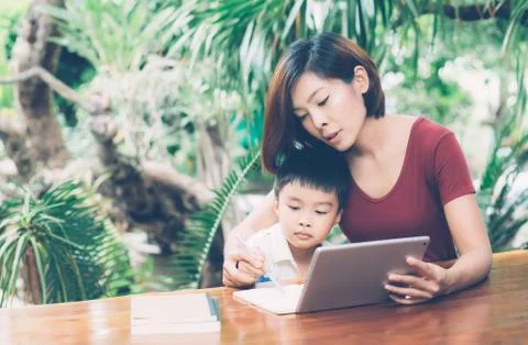 Son using digital tablet computer for study and learn to internet online with 스톡 사진