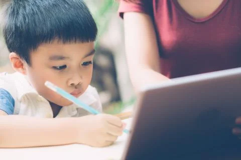 Son using digital tablet computer for study and learn to internet online with 스톡 사진