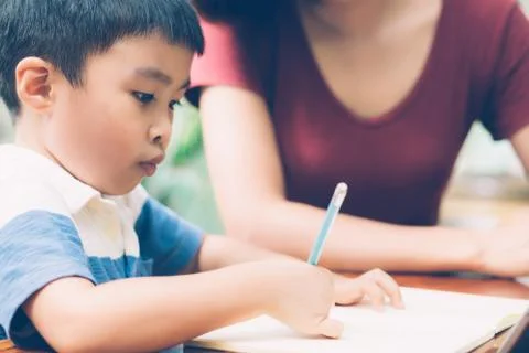 Son using digital tablet computer for study and learn to internet online with 스톡 사진