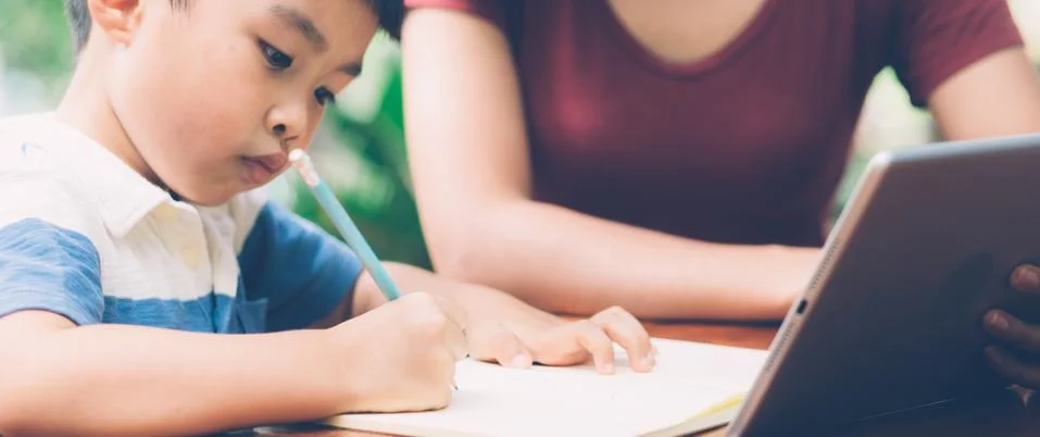 Son using digital tablet computer for study and learn to internet online with 스톡 사진