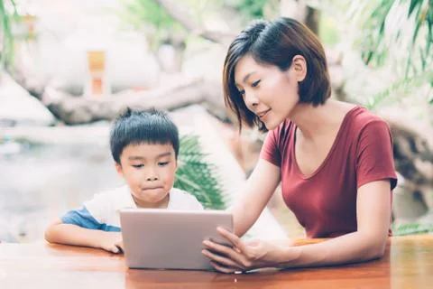 Son using digital tablet computer for study and learn to internet online with 스톡 사진