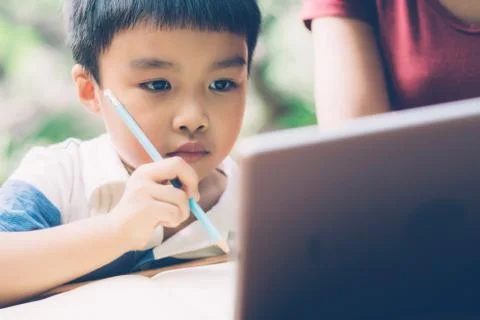 Son using digital tablet computer for study and learn to internet online with 스톡 사진