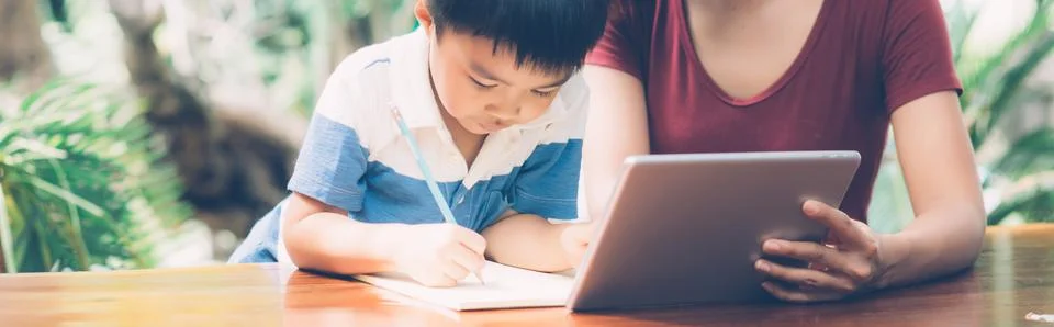 Son using digital tablet computer for study and learn to internet online with 스톡 사진