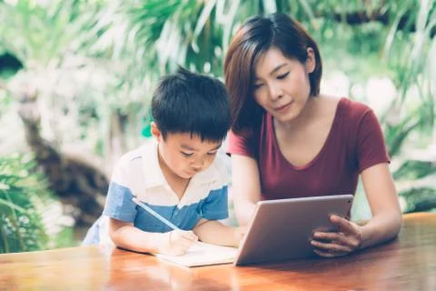 Son using digital tablet computer for study and learn to internet online with 스톡 사진