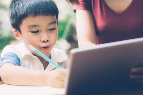 Son using digital tablet computer for study and learn to internet online with 스톡 사진