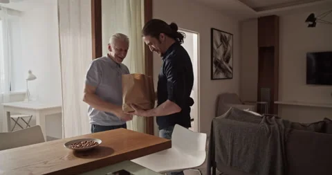 Son visiting father with present Stock Footage 196237009