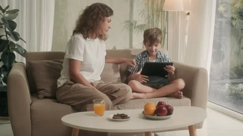 Son Watching Videos on Digital Tablet, Mother Asking to Turn Tablet Off 스톡 동영상 244695145