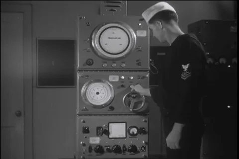 Sonar man checks the basic dial settings of sonar equipment - 1940 Video stock 106075138