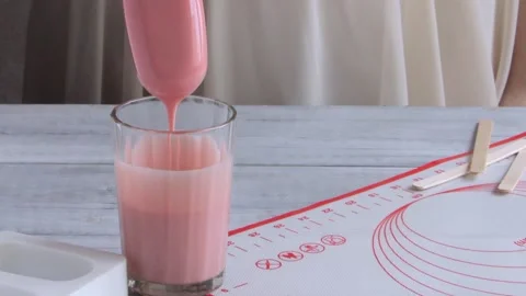 Сonfectioner dips an Ice cream cake into the pink chocolate glaze. Process of pr Stock Footage 150463743