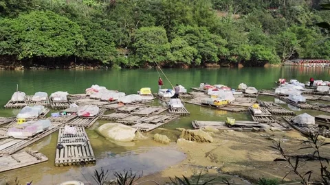Song Quay Son River at Ban Gioc with a floating Market between Vietnam and China Stock Footage 131344053