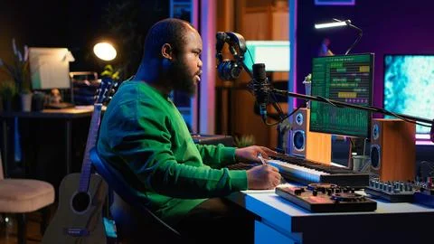 Songwriter taking notes to create new tracks for an album in his home studio Foto stock
