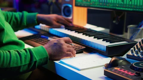 Songwriter writes down lines and melodic elements to create new tunes Stock Footage 281374867