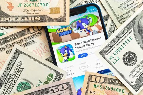 Sonic Dash mobile game app. Money background. Concept, company making money w Stock Photos
