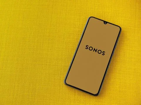 Sonos app launch screen on smartphone on yellow fabric background Stock Photos