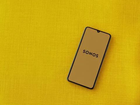 Sonos app launch screen on smartphone on yellow fabric background Stock Photos