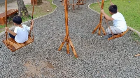 Sons swinging on swing-set Видео 228147591