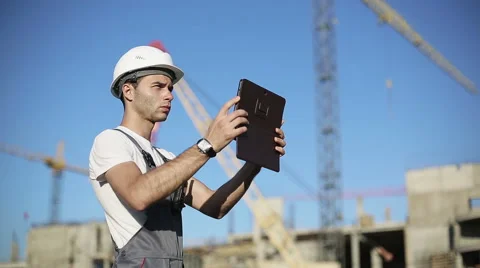 Сonstruction engineer with the tablet pictures of objects Stock Footage 53465799