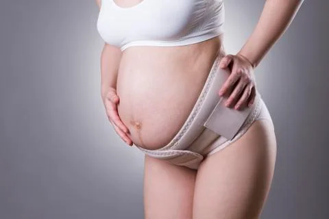 SONY DSC Pregnant woman in white underwear with orthopedic support belt,  preg Stock Photo #79319745