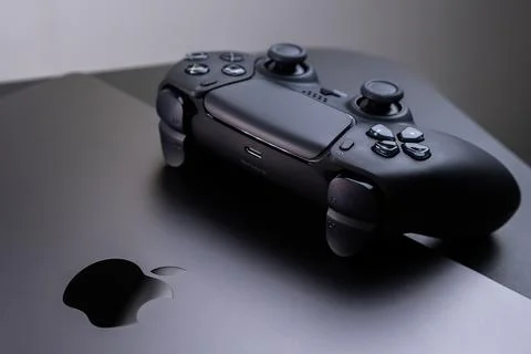 Sony DualSense Video Game Controller for Gaming on an Apple MacBook Pro Space Stock Photos