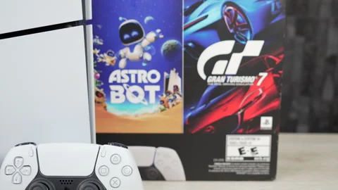 Sony PS5 console bundle with Astro Bot and Gran Turismo 7 and dual controllers Stock Footage 343907798