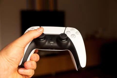 Sony PS5 Wireless Controller,on an oak wooden table,PlayStation is video gaming Stock Photos