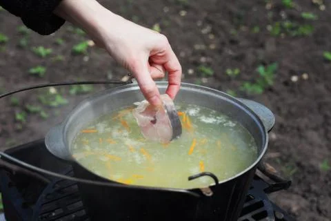 Сooking fish soup on the fire Stock Photos