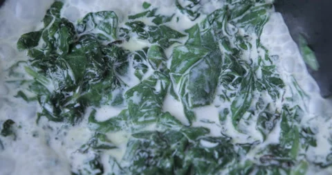 Сooking spinach in frying pan Stock Footage 118764451