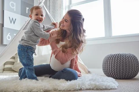 Soon hell have a sibling to join in on the fun. a pregnant woman bonding with Stock Photos