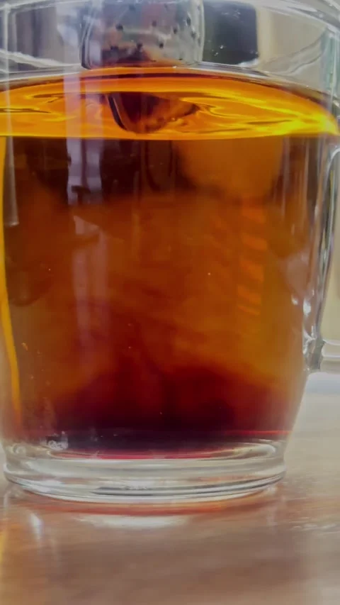 Soothing Cup Of Steaming Tea Showcasing Amber Shades And Gentle Wisps Of Vapor Stock Footage 326044139