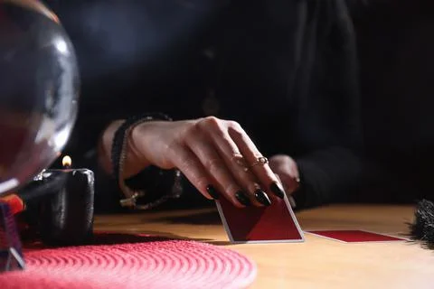 Soothsayer predicting future with cards at table indoors, closeup Stock Photos