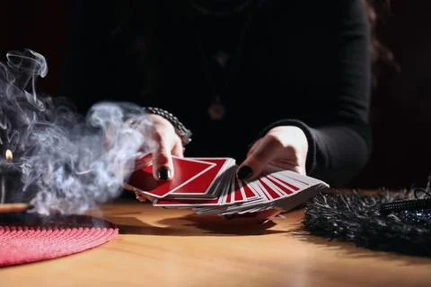 Soothsayer predicting future with cards at table indoors, closeup 写真素材