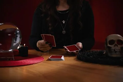 Soothsayer predicting future with cards at table indoors, closeup Stock Photos