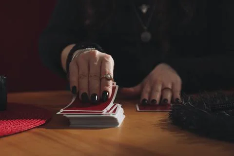 Soothsayer predicting future with cards at table indoors, closeup Stock Photos