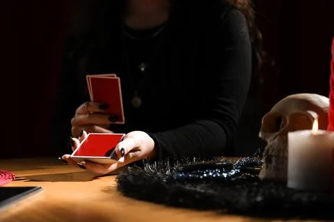 Soothsayer predicting future with cards at table indoors, closeup Stock-Fotos